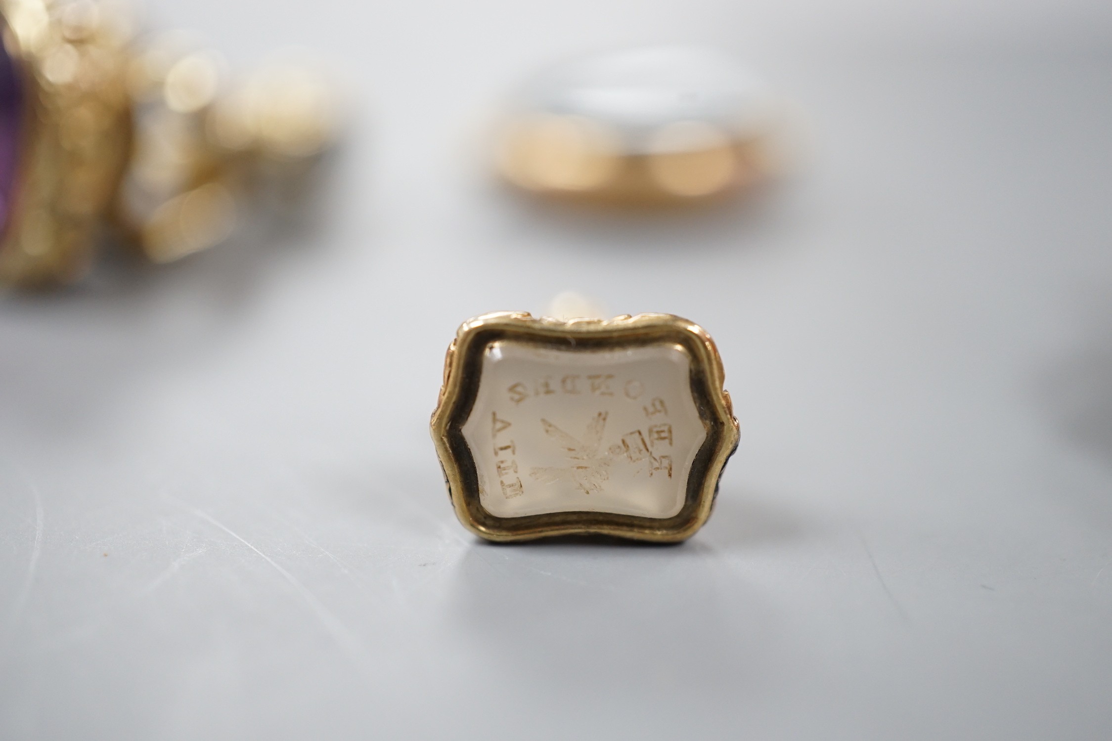 Six assorted late 19th/early 20th century gem set fob seals, including yellow metal overlaid with red intaglio stone carved with Roman soldiers, two 9ct gold, carnelian and bloodstone and a carnelian carved with family c